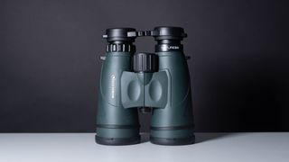 A full view of the binoculars on a white table and black backdrop